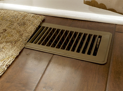 AC vent covered with rug