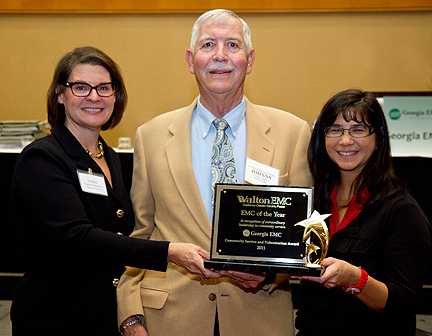 Walton EMC has been named EMC of the Year at the Georgia EMC annual meeting in Atlanta. Award judge Vickie Williamson, board chair of Hands on Georgia, presents the award to Walton EMC Director Johnny Allgood and Community Specialist Kathy Ivie.