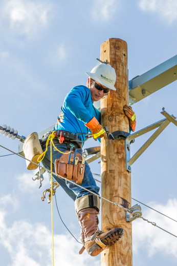 Apprentice Line Technician Adam Simmons secures his climbing belt as he begins an event at the Georgia Lineman's Rodeo near Fort Valley. Simmons placed first in the apprentice division and other events.