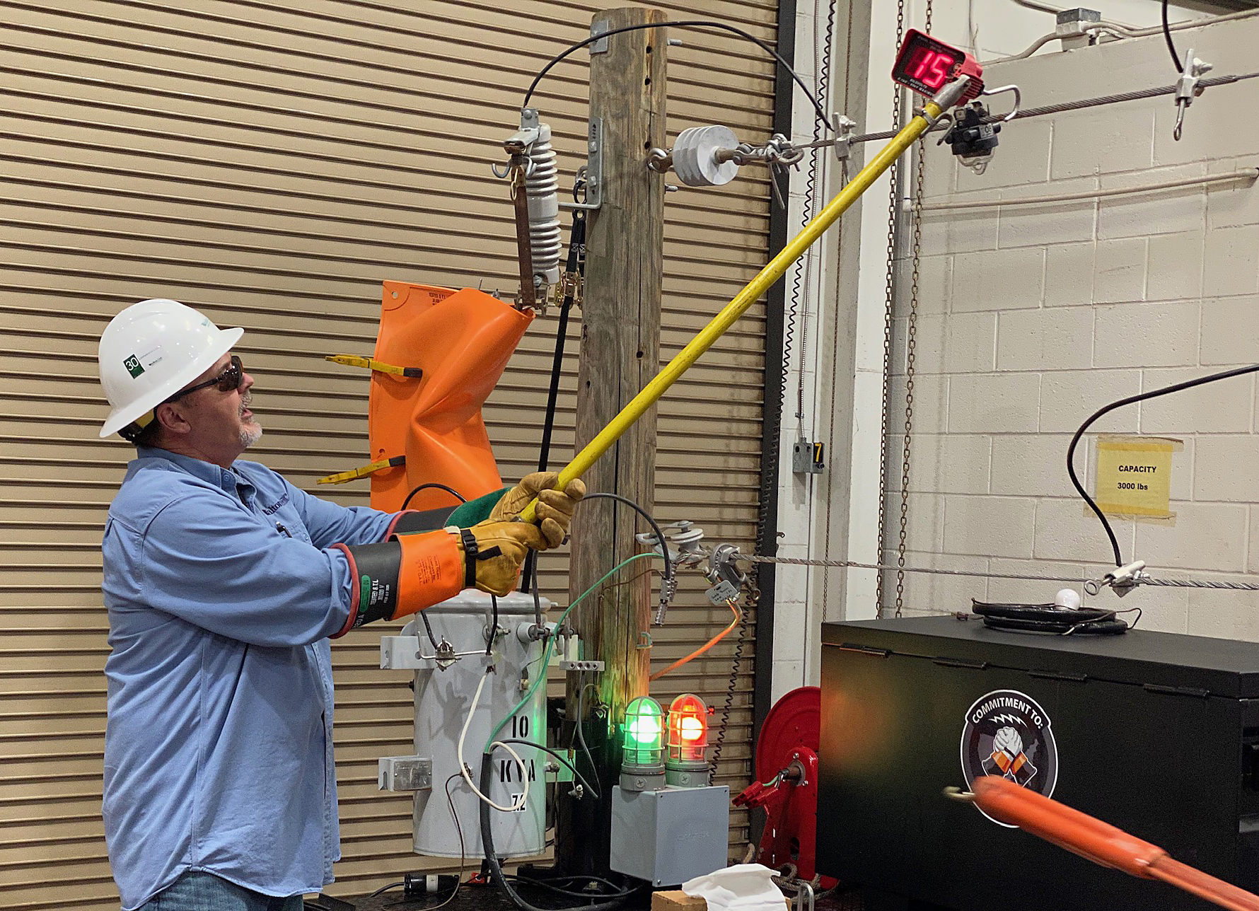 A Walton EMC employee demonstrates an electric line meter